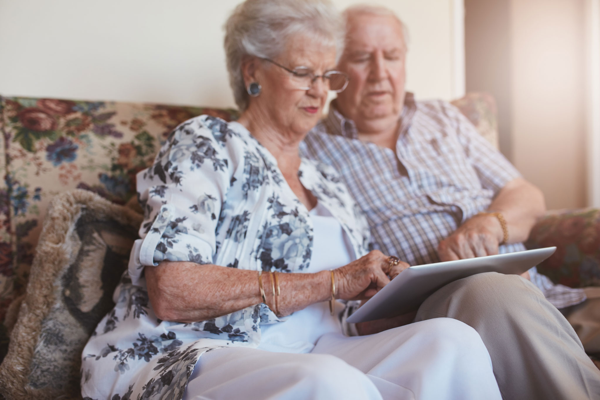 Couple looking up information on touchpad